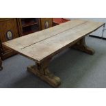 A 17th century style oak refectory table, the cleated plank top on a pair of trestle supports,