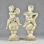 A set of three reconstituted stone figures of cherubs,