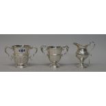 Silver, comprising; a George V twin handled trophy cup, with partly embossed acanthus decoration,