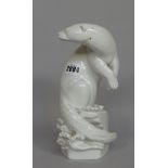 A Meissen white glazed porcelain otter, signed 'M.