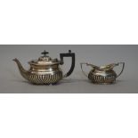 A silver teapot, with partly fluted embossed decoration and gadroon border, Chester 1902,