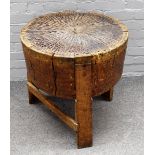 A 19th century oak tree trunk chopping block, with metal inset top on three block supports,