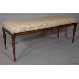 A rectangular footstool on mahogany baluster supports, 118cm wide x 48cm high.