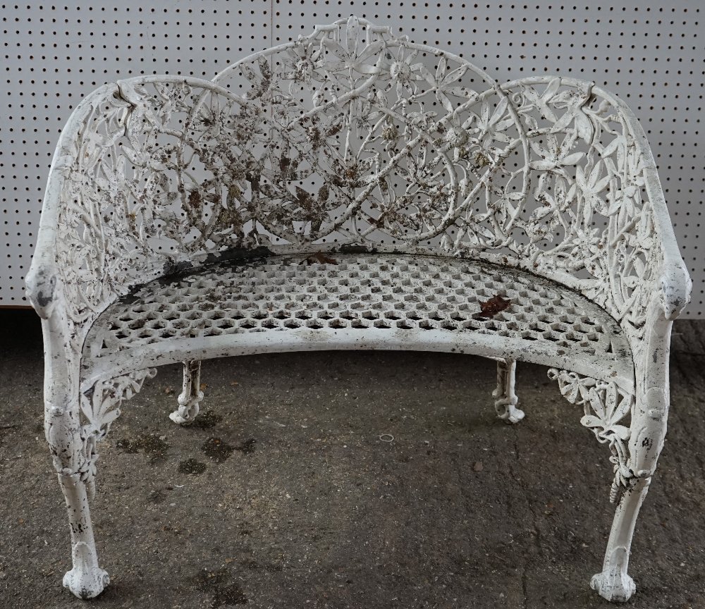 A pair of white painted Coalbrookdale style cast aluminum shaped benches,