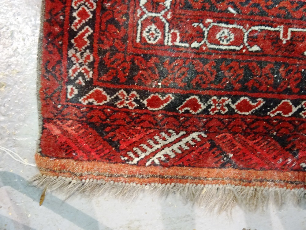 An Afghan rug, 184cm x 113cm and two Beluchi rugs, 136cm x 77cm, 175cm x 92cm, (3). - Image 3 of 9