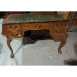 A mid-18th century style writing desk, the serpentine leather inset top over five frieze drawers,