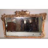 A 20th century pine overmantle mirror, with acanthus moulded crest, 110cm wide x 74cm high.