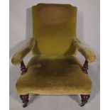 A Victorian mahogany framed low open armchair with green upholstery and a similar Victorian low