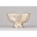 A Chinese bowl, of panelled form, decorated with sprays of differing blossom and bamboo,