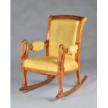 A Charles X field maple rocking chair, the arched back,