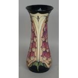 A Moorcroft 'Foxglove' pottery vase of waisted form, impressed and painted marks to base, boxed, 30.