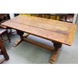 A 17th century style oak refectory table, the cleated plank top on carved bulbous supports,