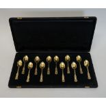 A cased set of twelve silver gilt tea spoons in the hourglass pattern, Vander London 1960, 220g.