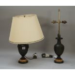 A pair of bronze urn form table lamps, on marble plinths with cream shades, 49cm high overall.