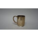 A silver mug, of plain cylindrical form,