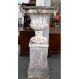 A large reconstituted stone jardinière with twin scroll handles on stepped square pedestals,