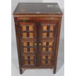 A 20th century hardwood side cabinet with Greek key border decoration, 55cm wide x 95cm high.