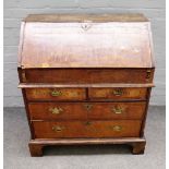 A George I featherbanded walnut bureau,