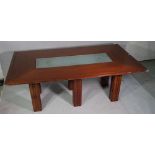 A 20th century stained beech rectangular dining table, with inset glass middle on block supports,