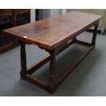 A 17th century style oak refectory table, the cleated plank top on turned supports,