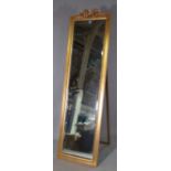 A 20th century gold painted floor standing dressing mirror with ribbon tied crest,