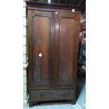 A George III style mahogany double wardrobe, panelled doors over single drawer on bracket feet,