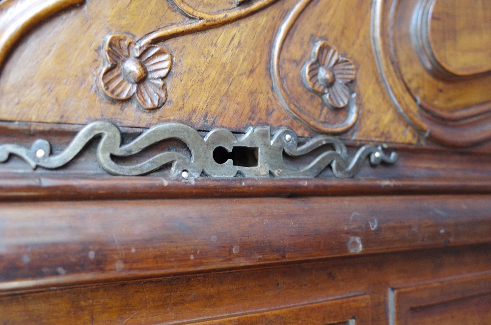 An 18th century fruitwood armoire with carved arched cornice over a pair of shaped panel doors, - Image 3 of 7