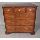 A George III mahogany chest of three short and three long graduated drawers with canted fluted