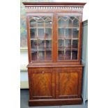 A mahogany library bookcase, Regency top on associated base,