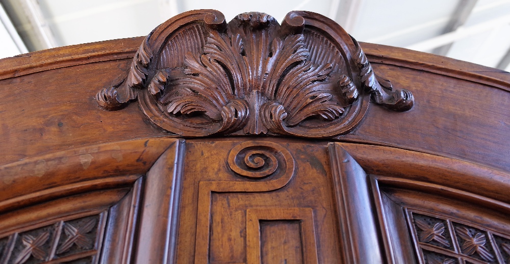 An 18th century fruitwood armoire with carved arched cornice over a pair of shaped panel doors, - Image 4 of 7