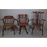 A late 19th century oak captains chair on turned supports,