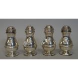 A set of four silver baluster shaped casters in the early 18th century manner, Searle & Co.
