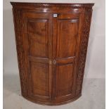 A George III mahogany corner cabinet with panelled doors, 88cm wide x 126cm high.