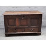 An 18th century oak mule chest, the lift top over triple panel front and pair of drawers,