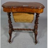 A Victorian figured walnut lift top work table on barley-twist supports, 67cm wide x 72cm high.