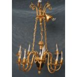 An ebonised and gilt brass Empire style nine branch chandelier, 20th century,