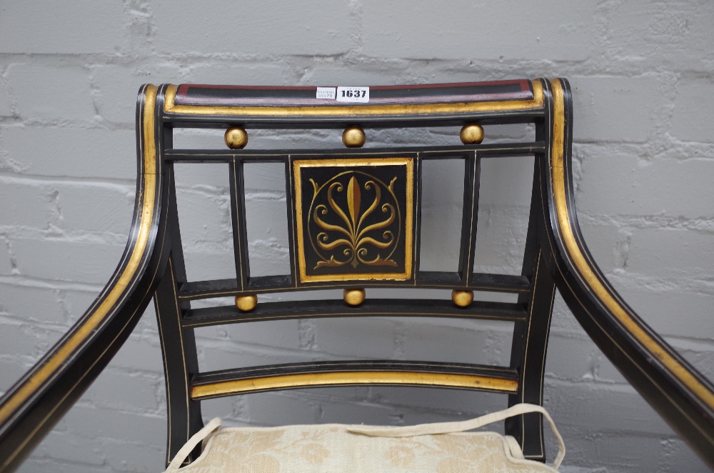 A pair of Regency style parcel gilt ebonised open armchairs on sabre supports, - Image 2 of 3