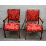 A pair of French Empire style gilt metal mounted mahogany open armchairs with caryatid mounts on