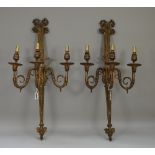 A pair of French gilt bronze three branch wall appliques, late 19th century, with bow surmount,