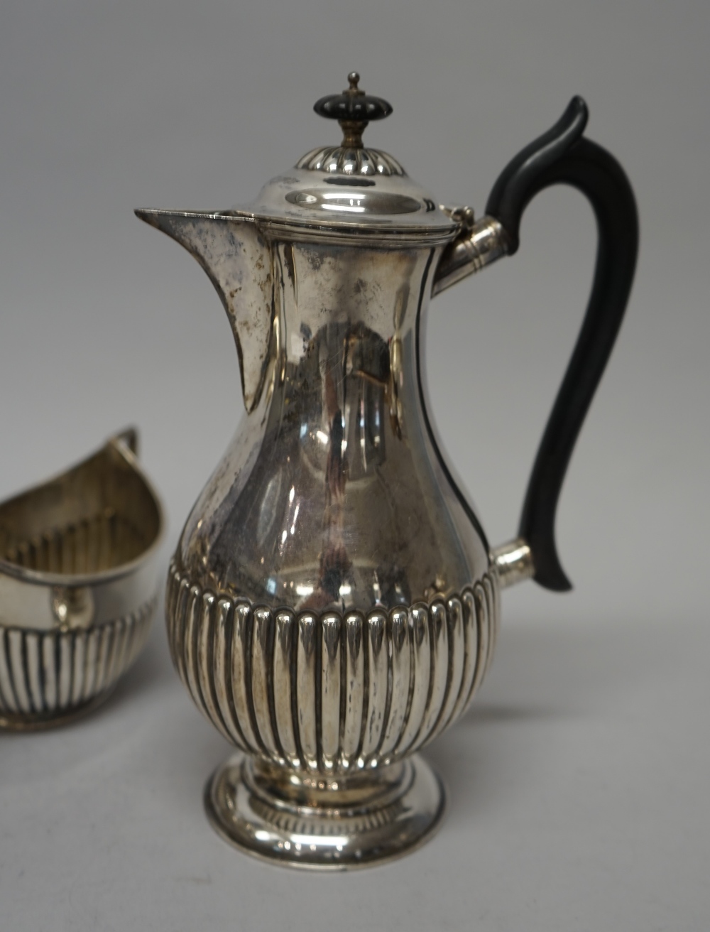 A silver composite four piece tea set, comprising; an oval teapot, with black composition fittings, - Image 5 of 6