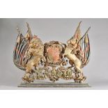 A polychrome painted cast iron plaque probably The Royal Warrant coat of arms, (a.f.