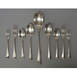 A silver rat tail pattern part table service, comprising; one stuffing spoon, five tablespoons,