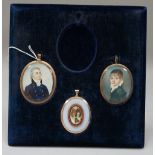 Mid-19th English school, a portrait miniature on ivory of a young boy in a green coat,