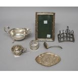 Silver and silver mounted wares, comprising; a shaped oval trinket dish, a sauceboat, a napkin ring,
