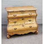 A 19th Century Dutch stripped pine bombé three drawer chest, 100cms wide, 87cms high.