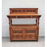 Gillow & Co; a Victorian carved oak buffet with pair of drawers over cupboard on baluster supports,