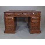 An early 20th century mahogany pedestal desk with tooled red leather top, 120cm wide x 70cm high.