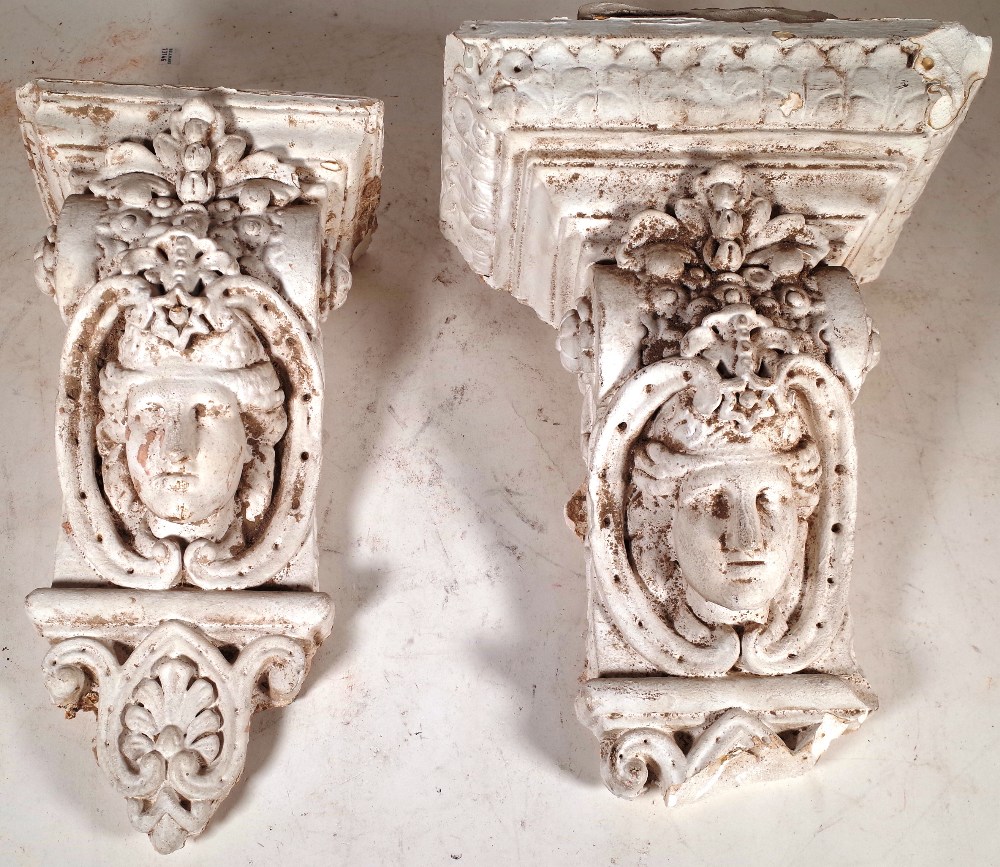 A similar pair of early 20th century plaster corbels with mask decoration, 46cm high.