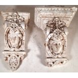 A similar pair of early 20th century plaster corbels with mask decoration, 46cm high.