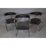 "Stell, 3 Duke Street Adelphi London", a set of three black leather upholstered tub back chairs,